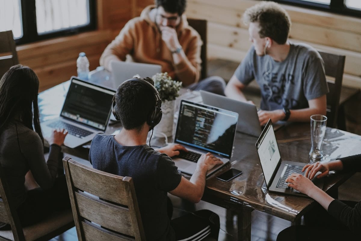 What Is Nonprofit Capacity Building? A Complete Guide for Canadian Organizations Team collaborating around a table with laptops — nonprofit capacity building