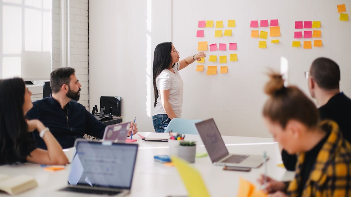 How to Build a Nonprofit Communications Strategy That Gets Results Nonprofit team reviewing communications plan on whiteboard