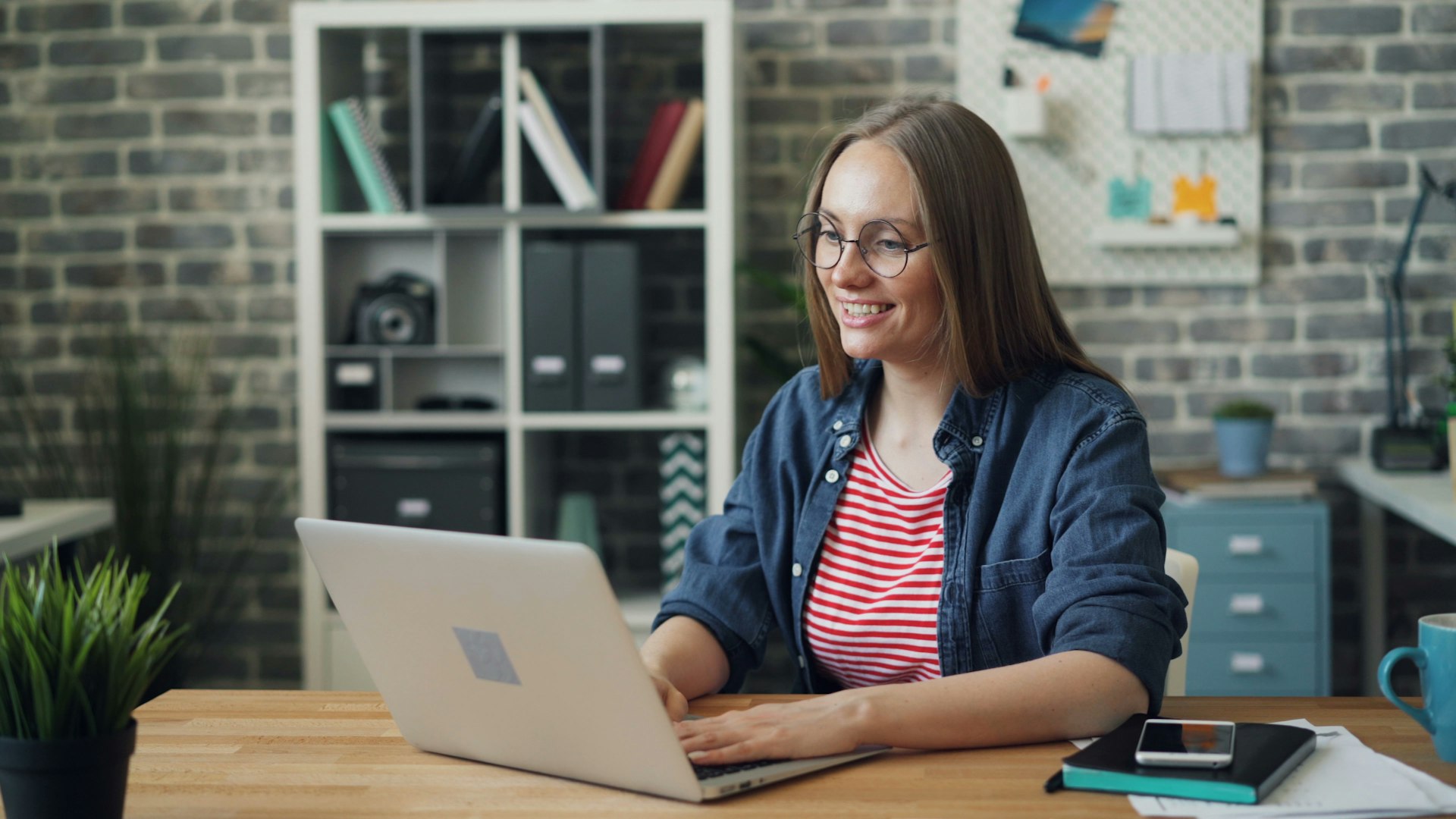 Nonprofit staff member writing a grant report on a laptop