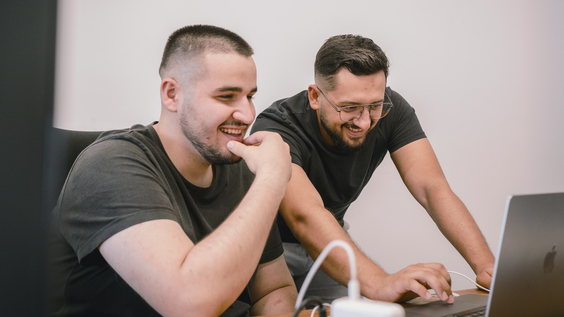 Two colleagues reviewing nonprofit social media content on a laptop