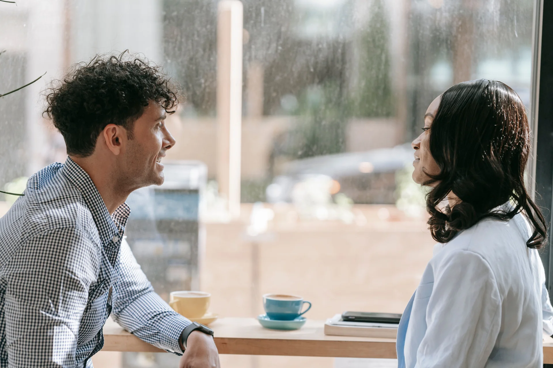 Two people talking over coffee