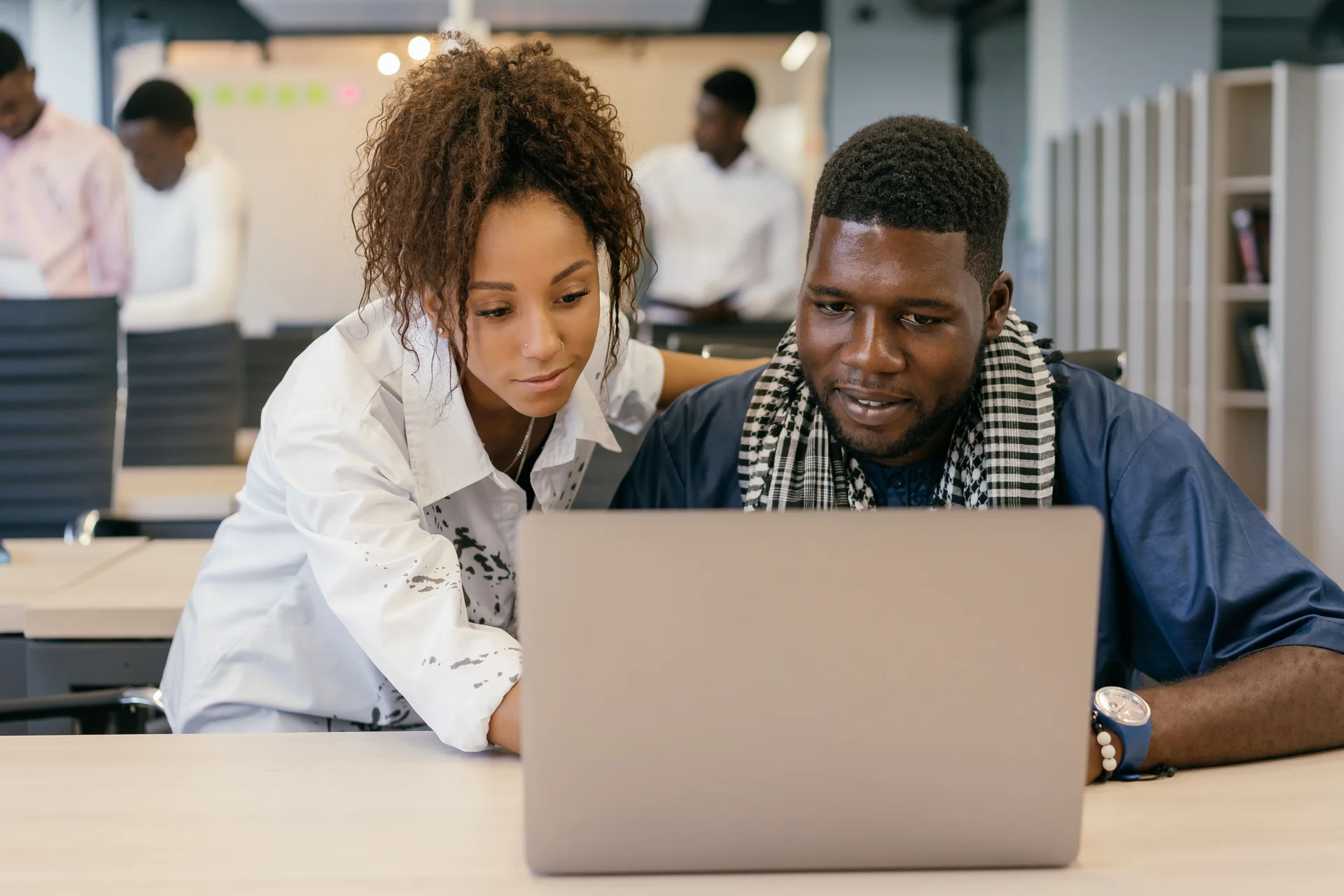 Google Ad Grants in Canada Two colleagues looking at results on a laptop