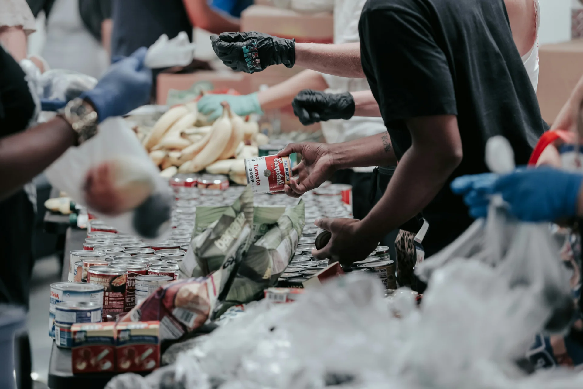 Volunteers sorting donated canned food
